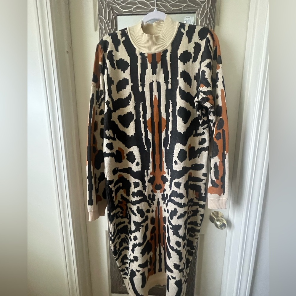 An abstract design creates a fun motif create this sweater dress.